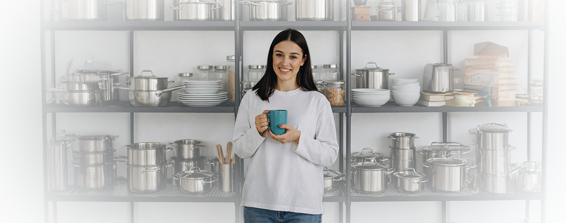 Woman holding a cup in a modern kitchen